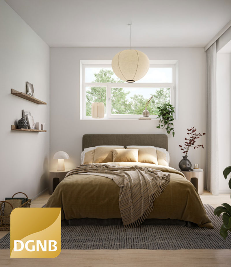 DGNB Guld-certifikatet placeret på et billede af soveværelset i lejeboligen 